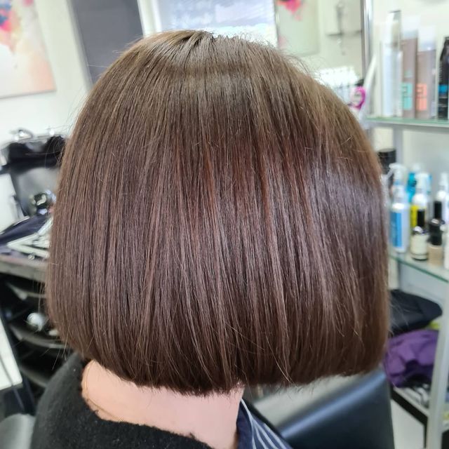 A Woman With Short Brown Hair is Sitting in a Chair in a Salon — Lush Hair Studio in Tumbi Umbi, NSW