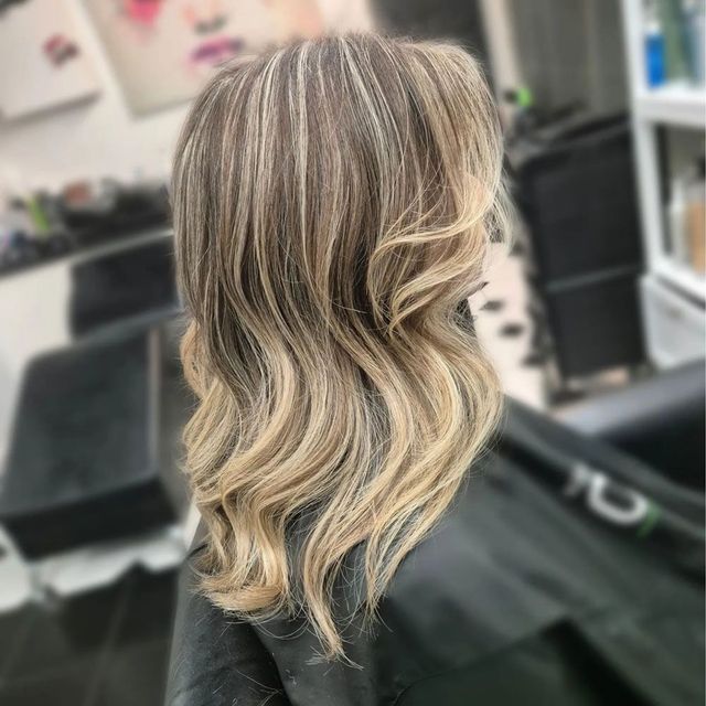 A Woman is Getting Her Hair Done in a Salon — Lush Hair Studio in Tumbi Umbi, NSW