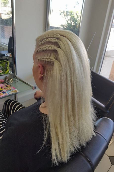 A Woman With Blonde Hair is Sitting in a Chair in a Salon — Lush Hair Studio in Tumbi Umbi, NSW