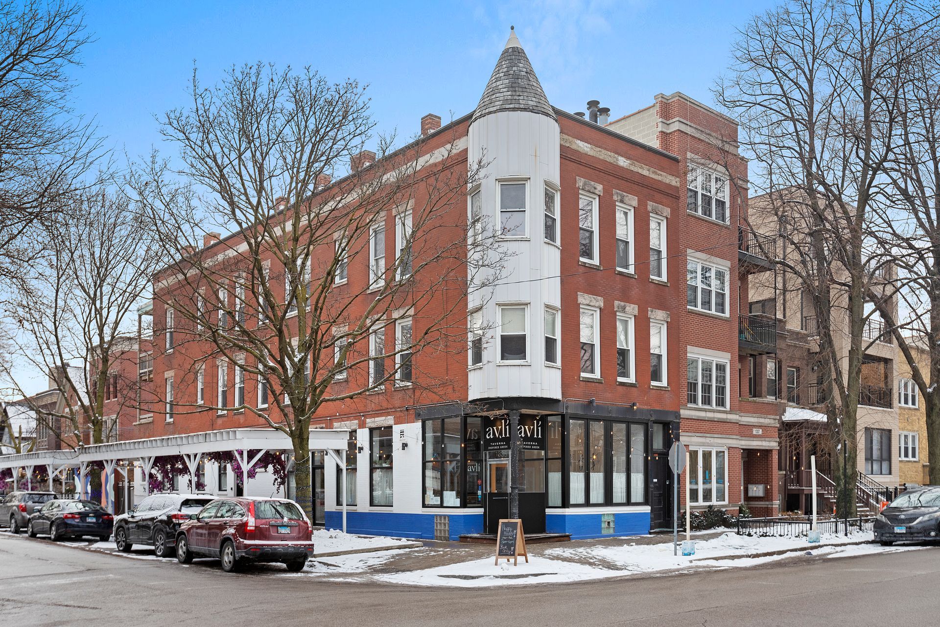A brick building with cars parked in front of it