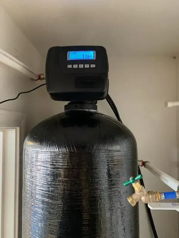 Water softener system with digital display showing 