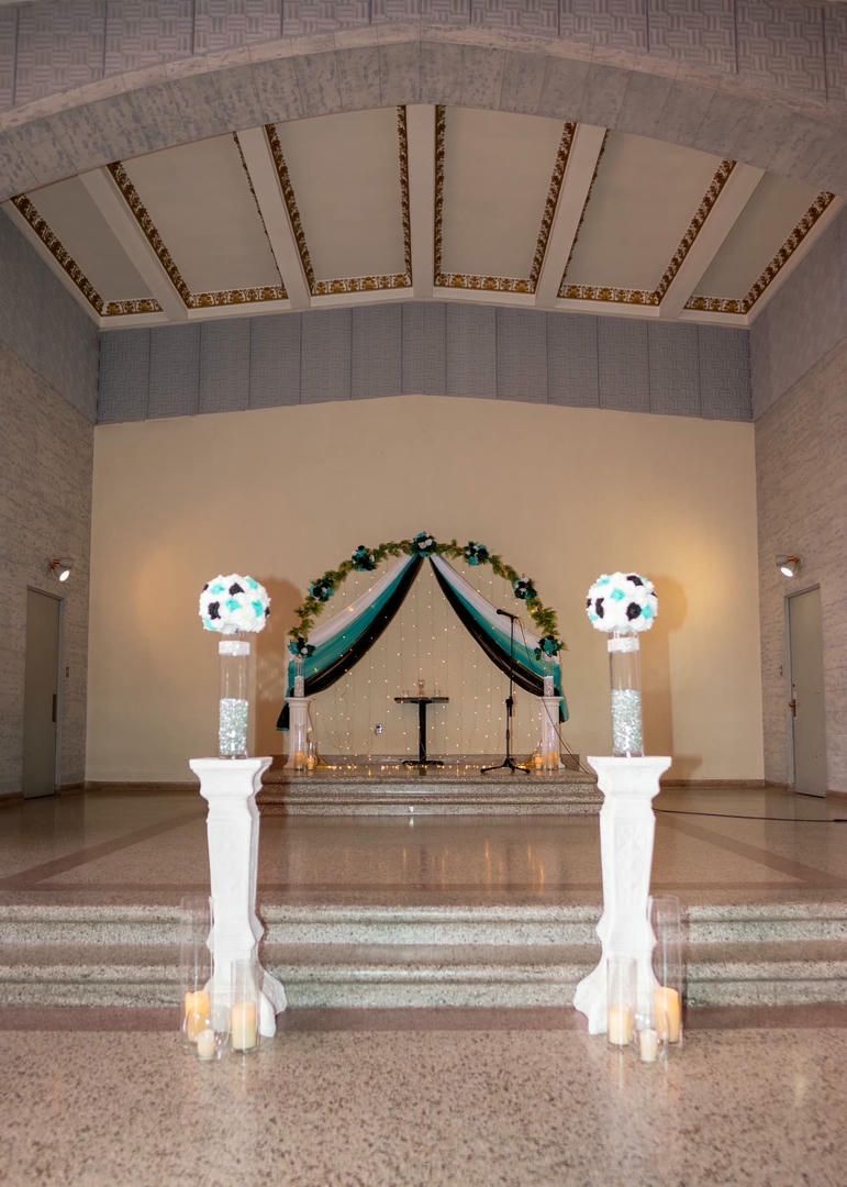 A large room with a podium and candles in front of it