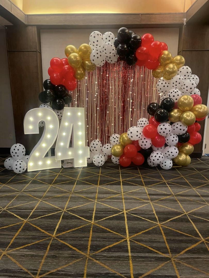 A room filled with balloons and a sign that says `` 21 ''.