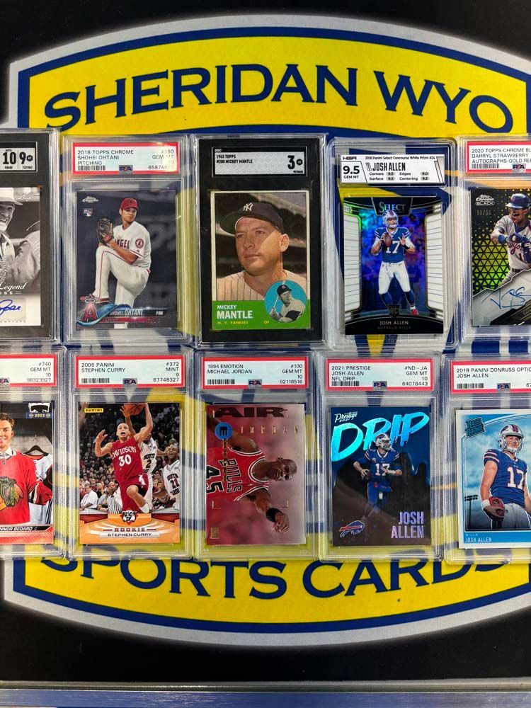 A display of sports cards in front of a sign that says sheridan wyc sports cards.