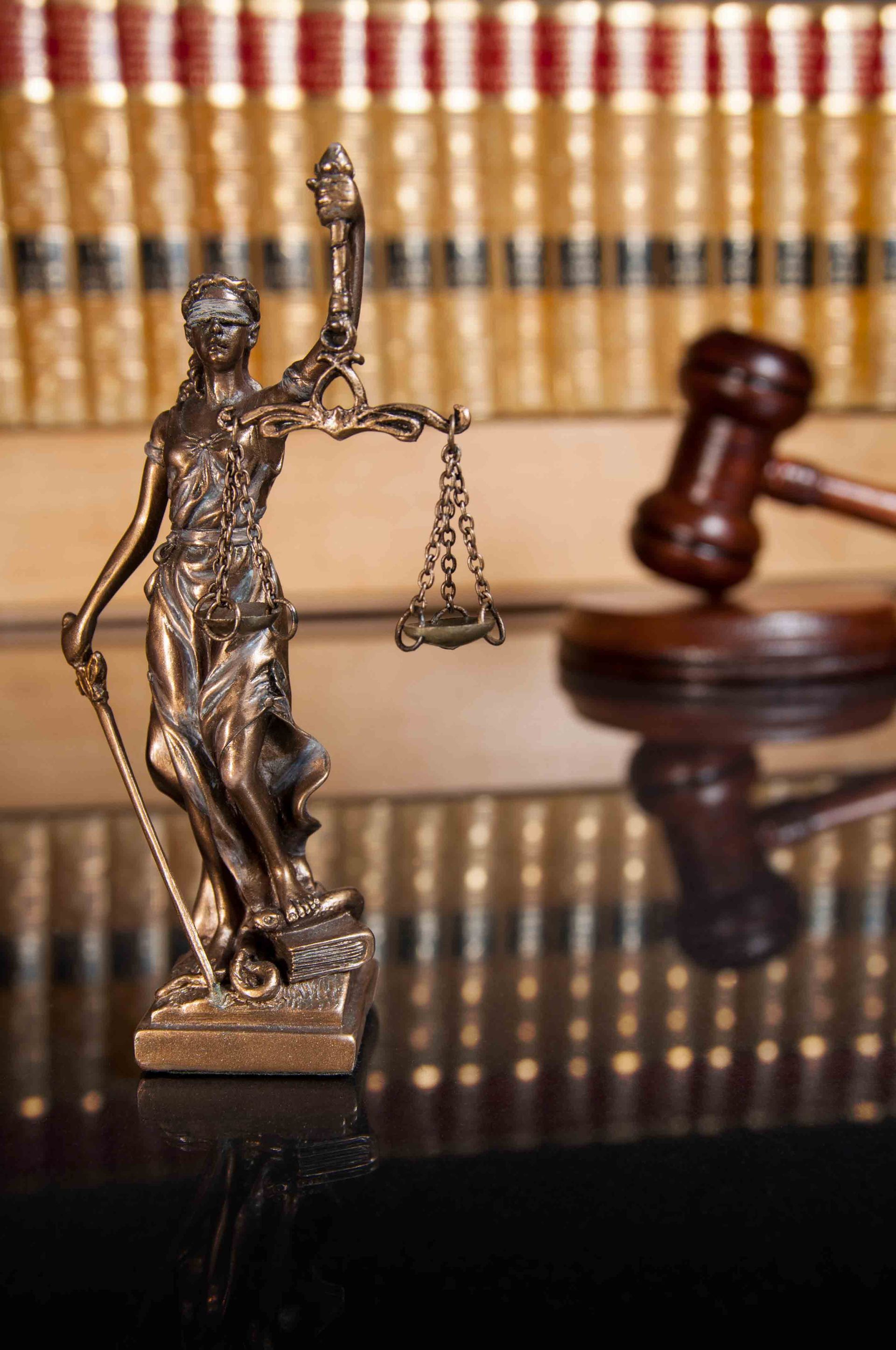 Lady Justice statue with scales on a table, symbolizing Criminal Defense Attorney, at Maruca Law 