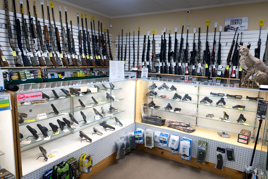 On Target Shooting Outfitters interior showing cases of guns for sale