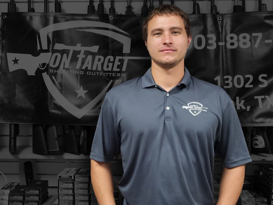 A man standing in front of a sign that says on target