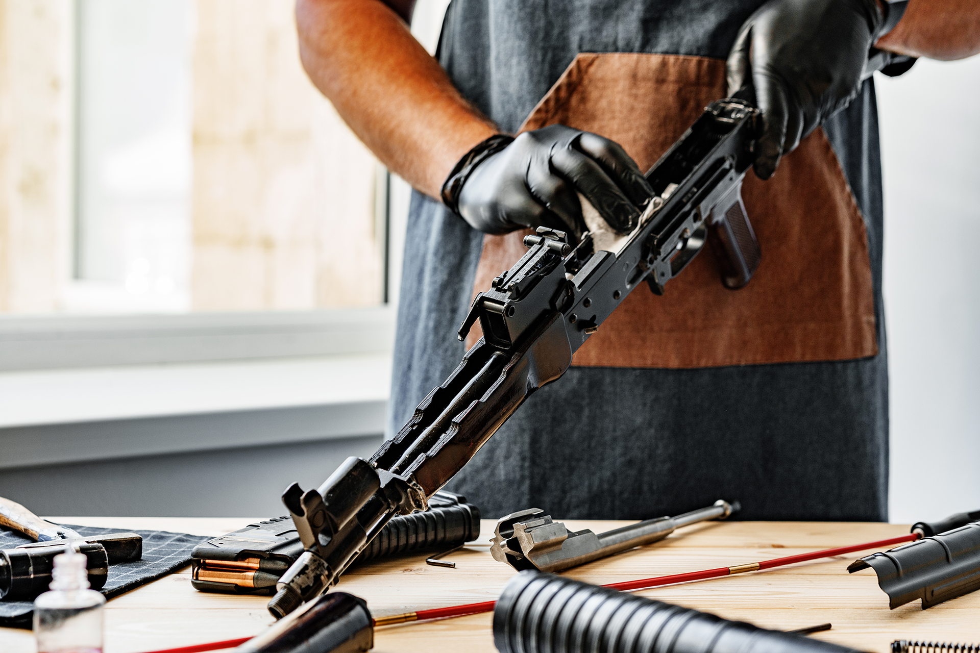 A man cleans a rifle
