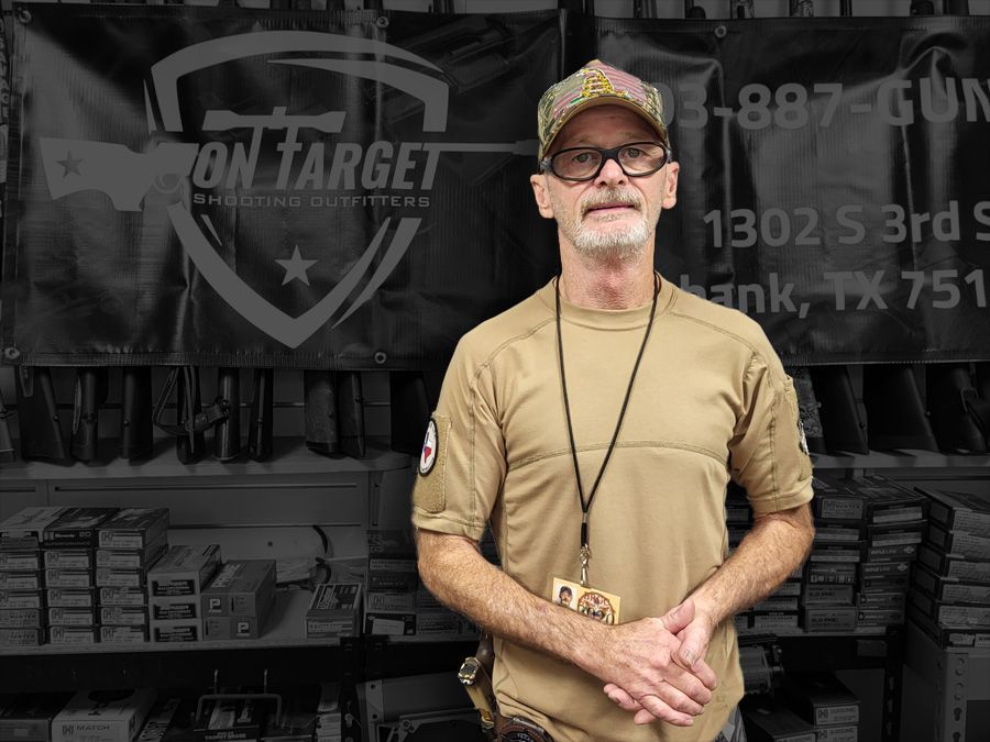 A man is standing in front of a sign that says ' on target '