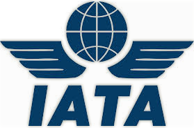 A blue logo for iata with a globe and wings