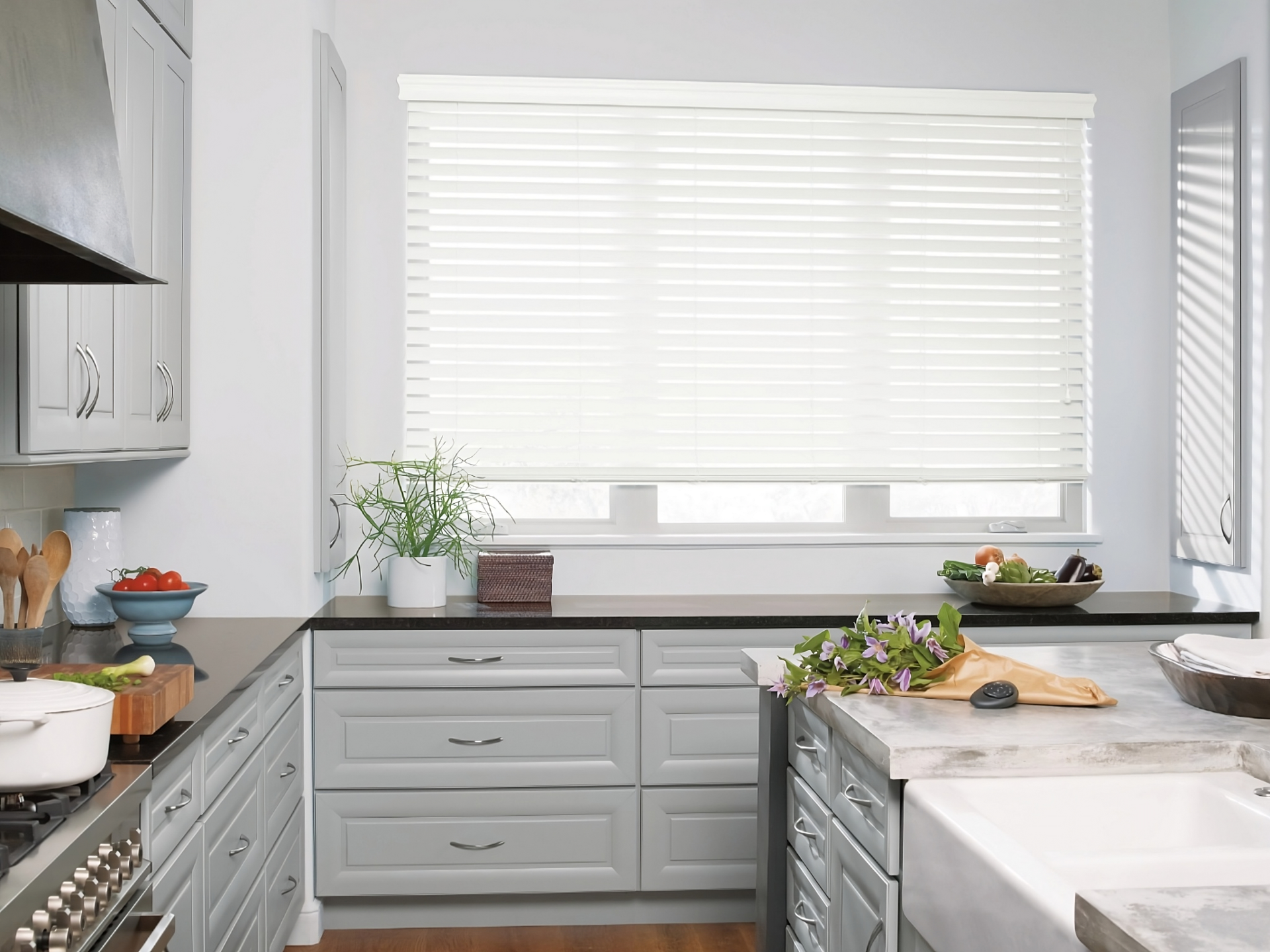 Custom Hunter Douglas window blinds for windows and doors in a chic and modern kitchen