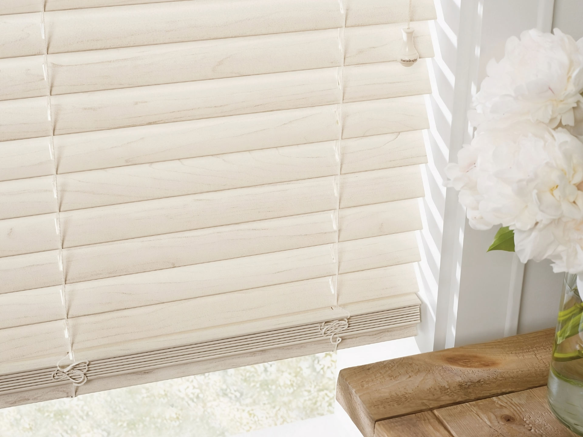 Custom Hunter Douglas window blinds for windows and doors in a chic and modern kitchen