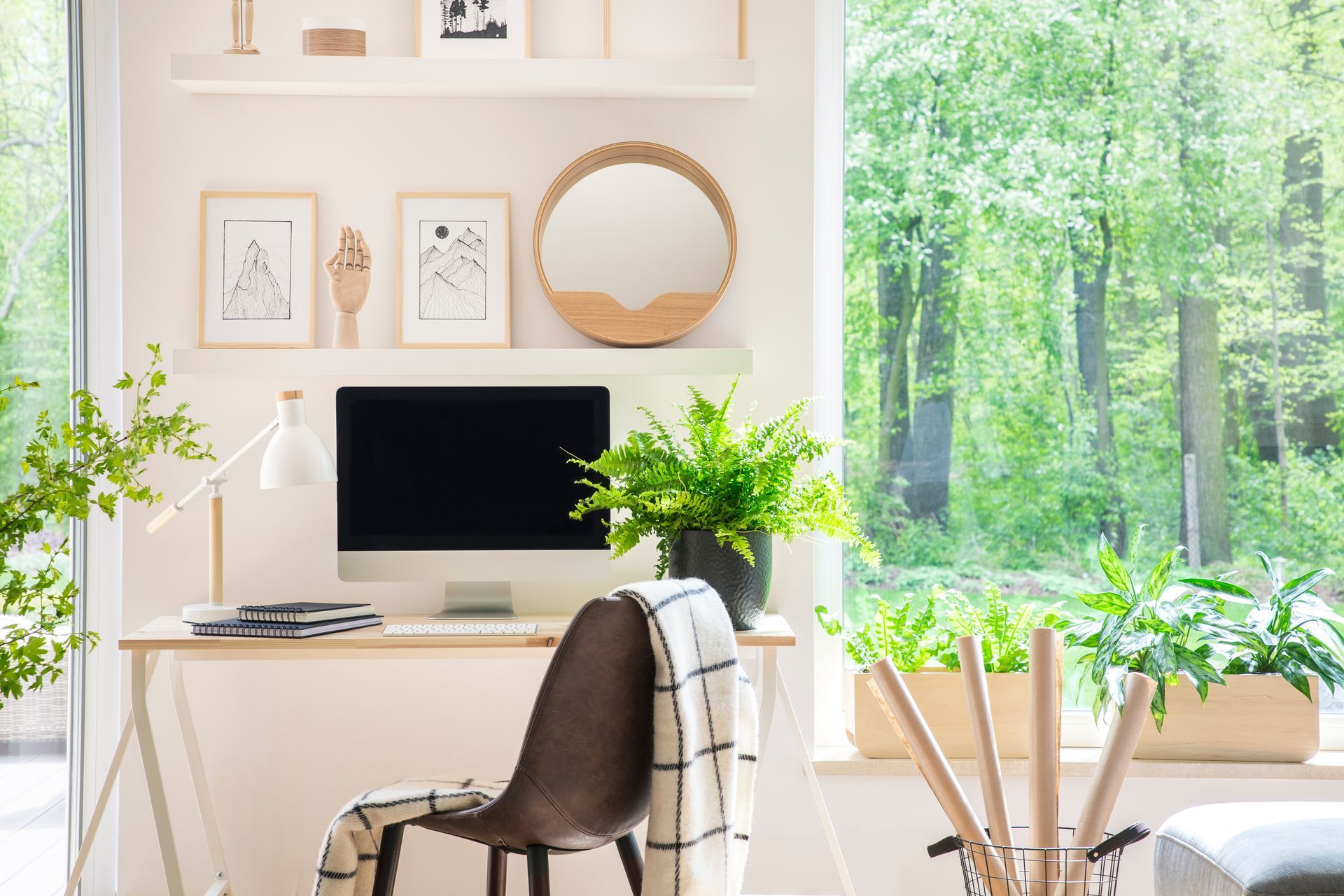 Expansive windows in a residential workspace that are in need of home office shades 