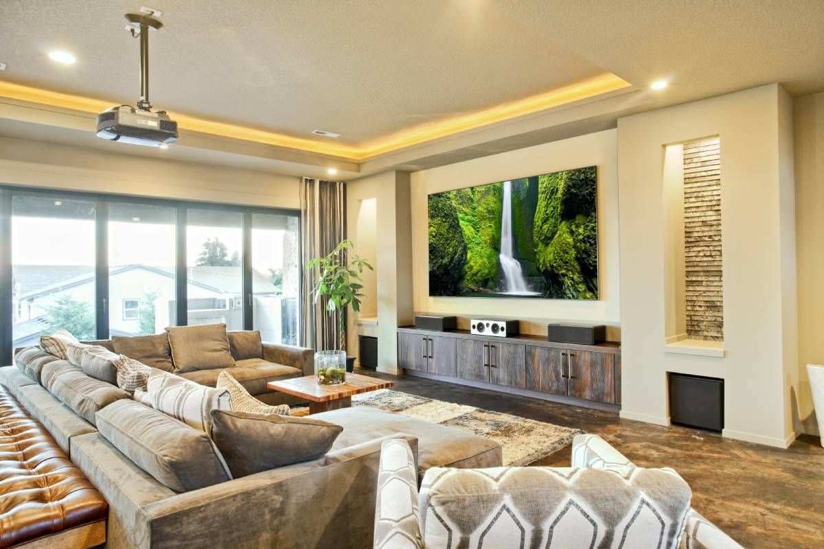 Home theater with a projector on the ceiling and custom drapes drawn open at the window