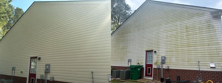 Two beige house sides with steep roofs and outdoor decks, seen from the backyard.