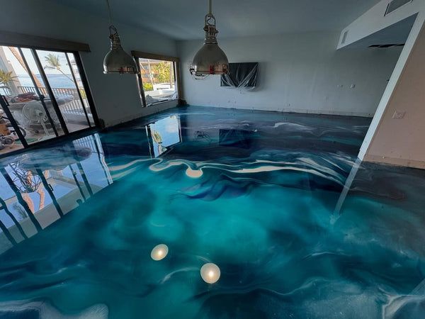Indoor pool room with glossy blue water, large windows, pendant lights, and a wall-mounted TV