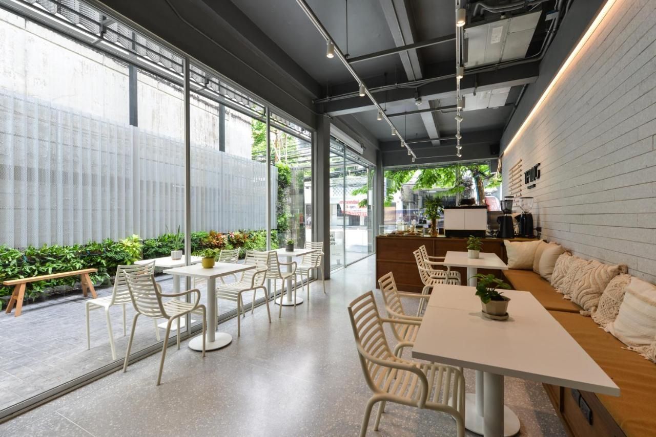 A restaurant with tables and chairs and a large window.