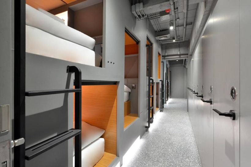 A long hallway with bunk beds in the corner