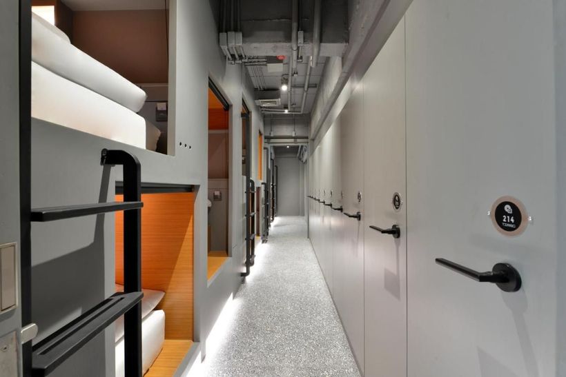 A long hallway with bunk beds and a door