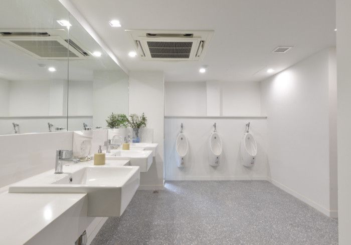 A public restroom with a lot of sinks and urinals.