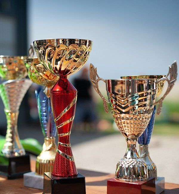 Golden Trophies With Colored Bases, Outdoors — CQR Locksmiths In Moree, NSW