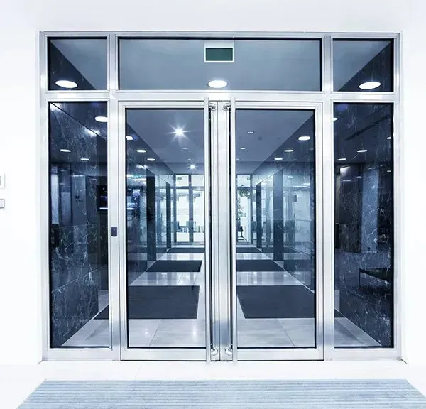 Glass Double Doors With Silver Frames Leading Into A Building — CQR Locksmiths In Moree, NSW
