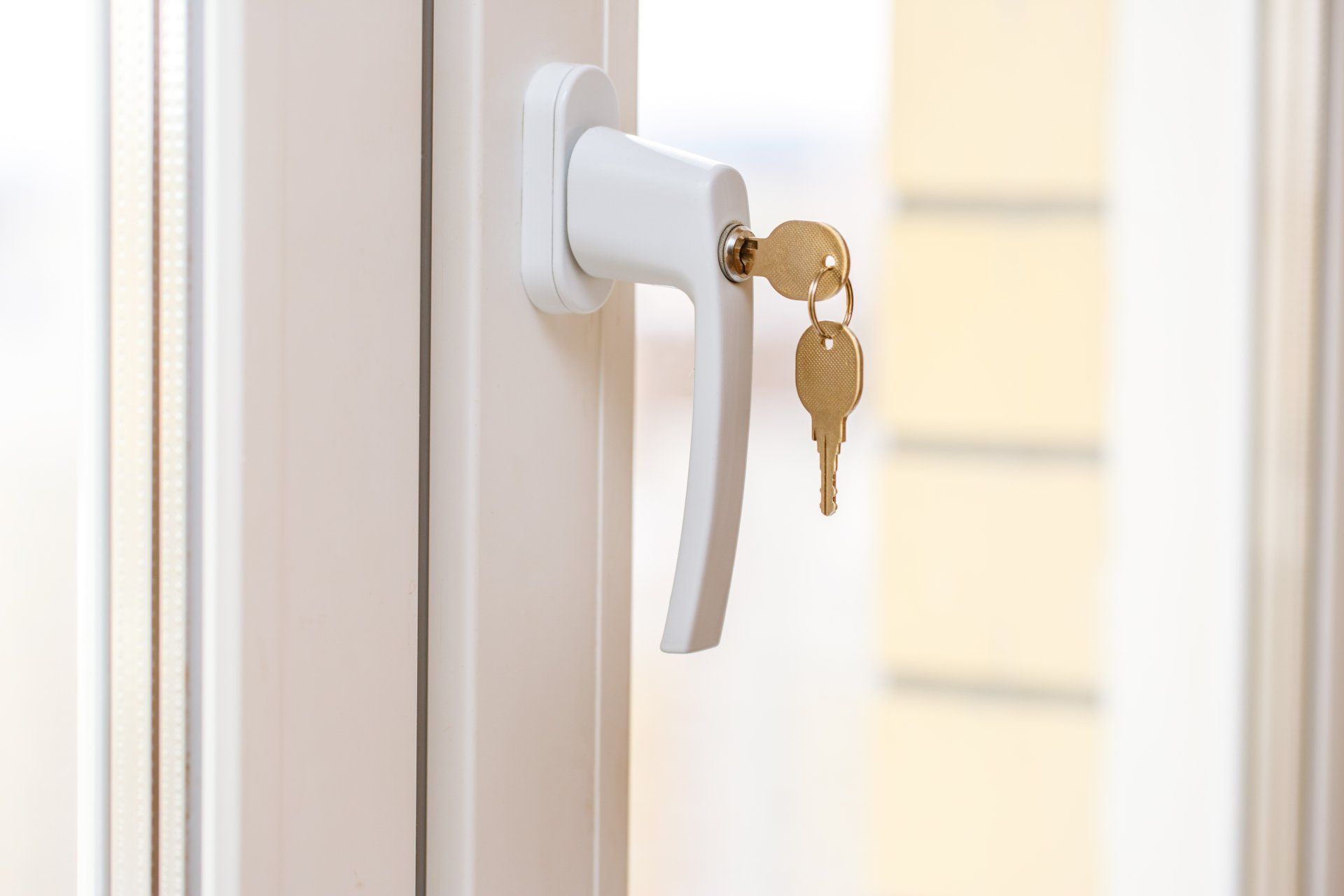 White Window Handle With Two Keys Hanging From The Lock — CQR Locksmiths In Moree, NSW