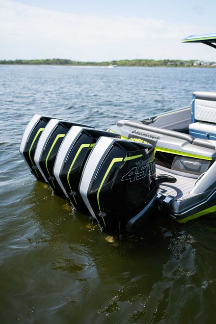Black and green inflatable boat bumper floating on a lake beside a docked pontoon boat