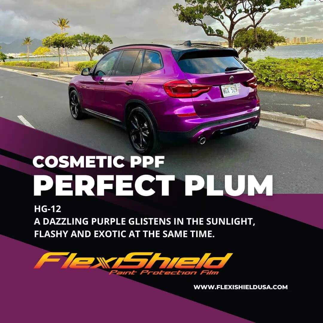 A purple car is driving down a road.