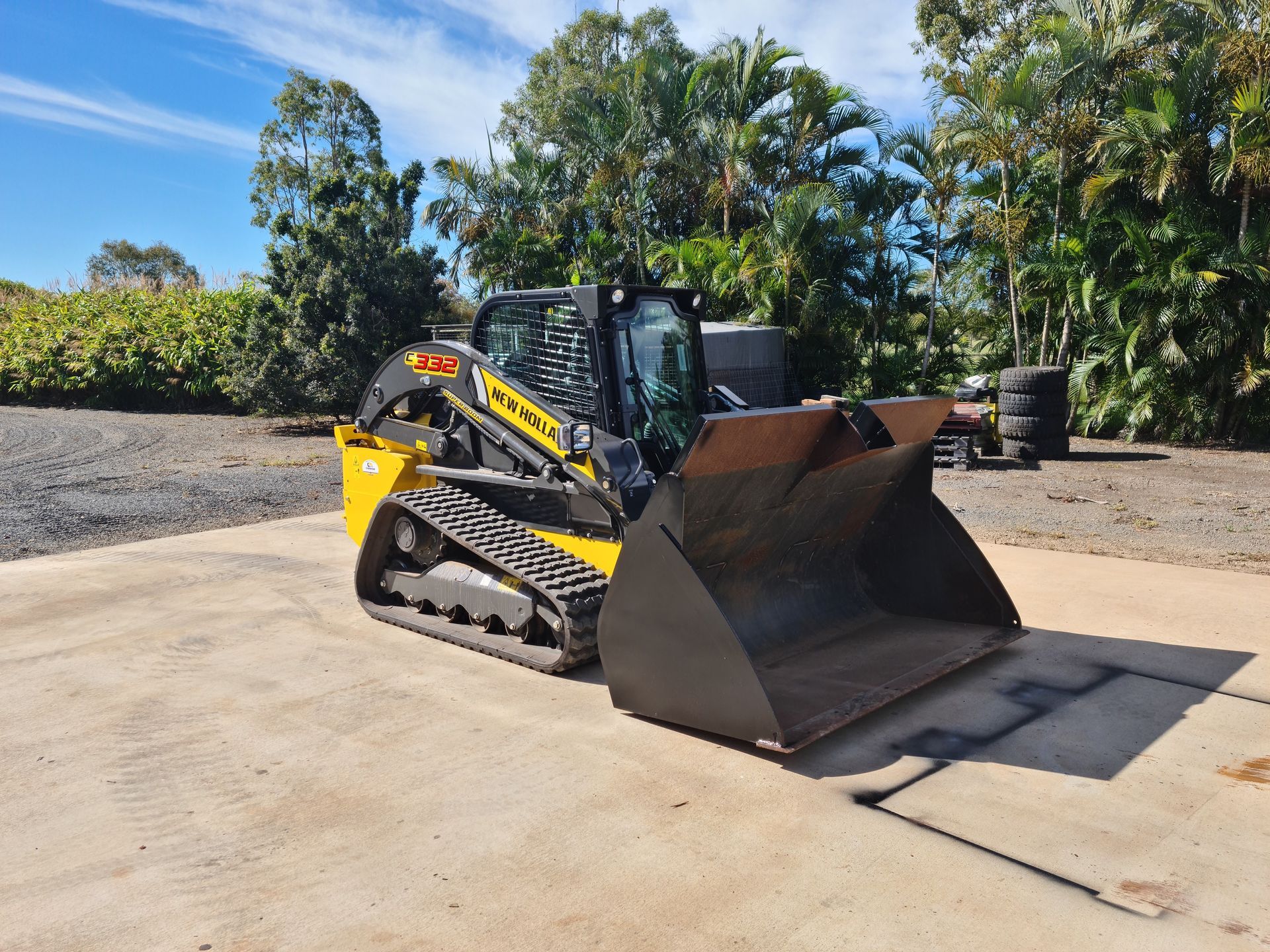 A Case Compact Track Loader is Parked on the Side of the Road — A1 Tree Service in Kensington, QLD