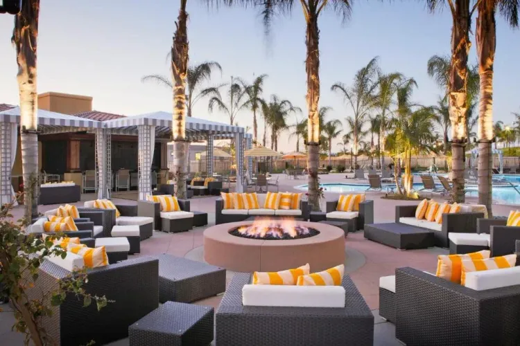 a fire pit in the middle of a patio area