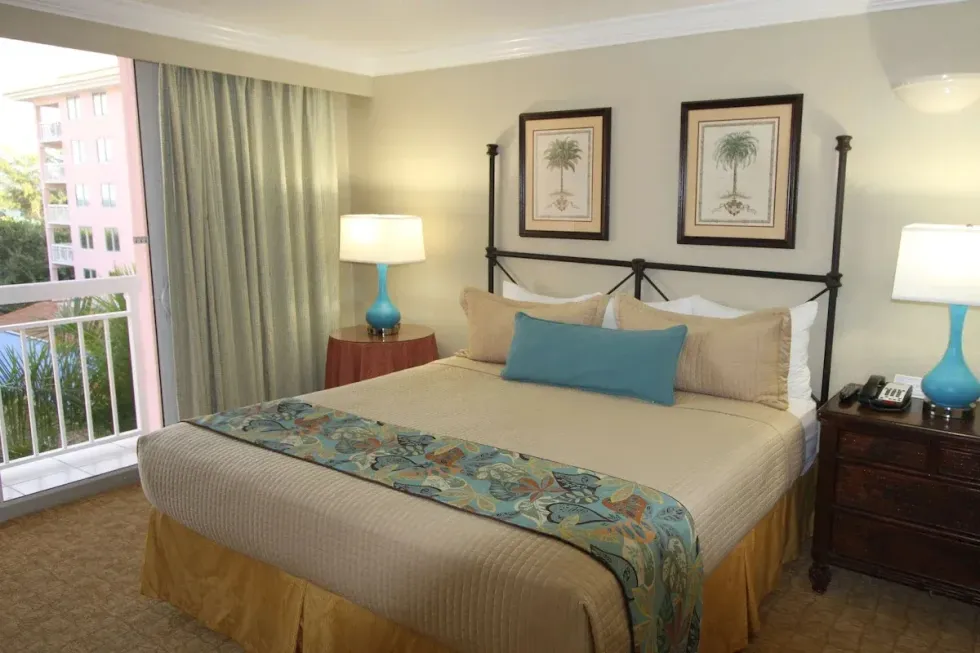 a hotel room with a king size bed and two lamps .