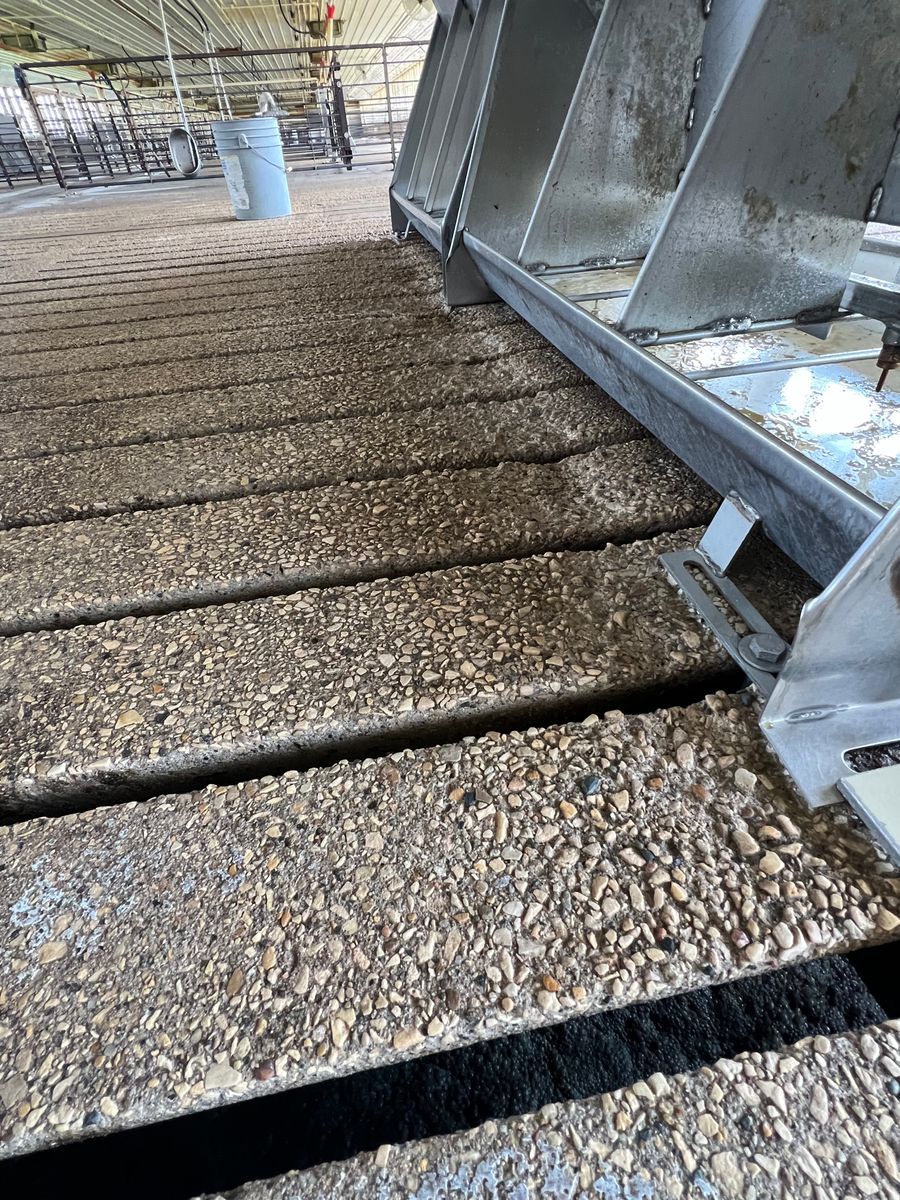 A close up of a metal structure with gravel on it.