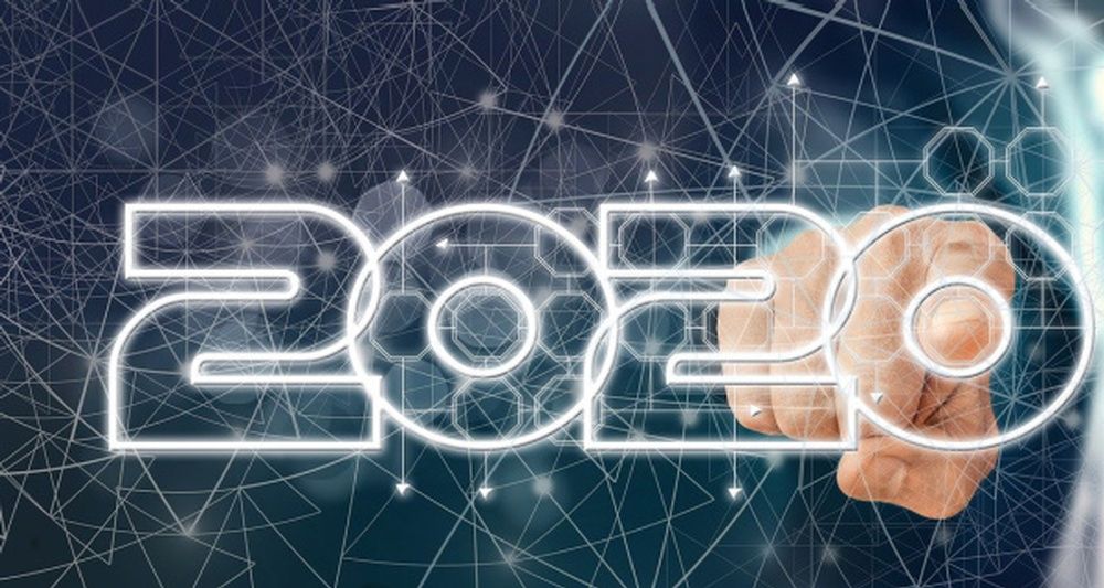 A person is pointing at the number 2020 on a screen.