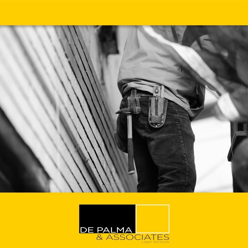 A black and white photo of a man with a hammer in his pocket.