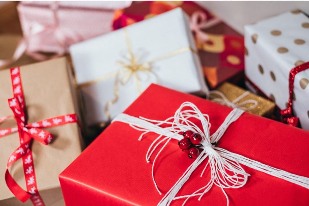 A pile of christmas presents wrapped in red and white paper