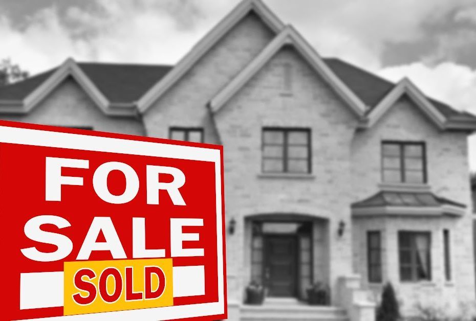 A house with a for sale sign in front of it