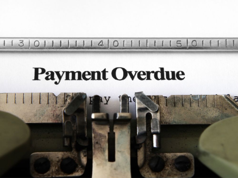 A typewriter with the word payment overdue written on it