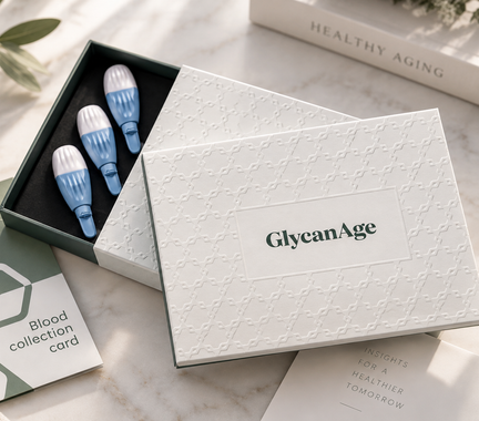 White GlycanAge box with blue test tubes on a soft beige tabletop