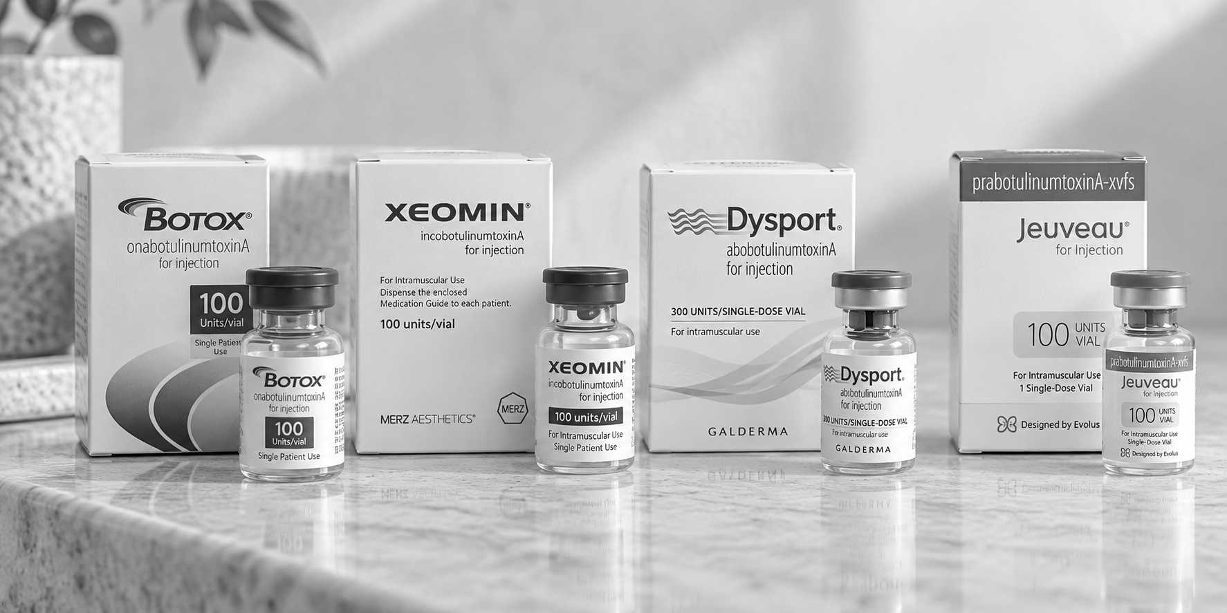 Assorted Botulax, Xeomin, Dysport, and Juveau vials and boxes arranged on a white surface