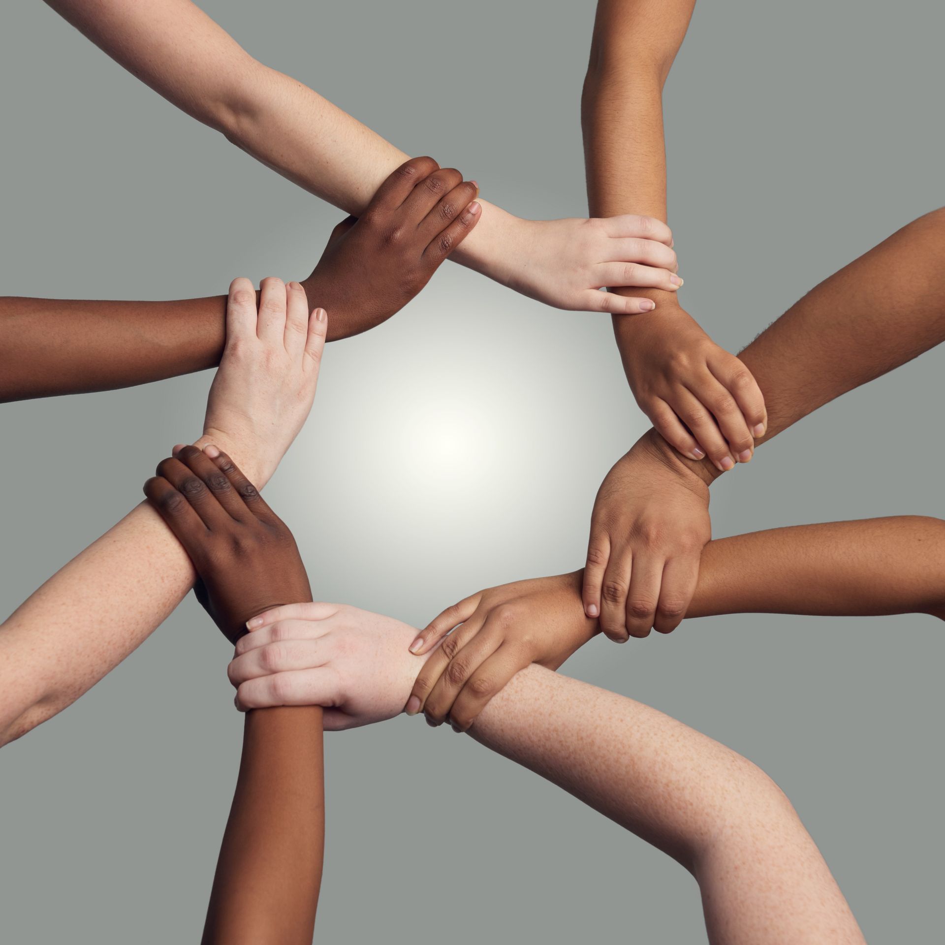 Hands piled together in a team huddle, symbolizing unity and collaboration.