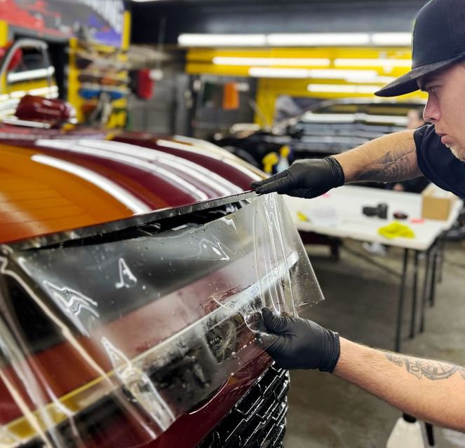 A man is working on a motorcycle in a garage.