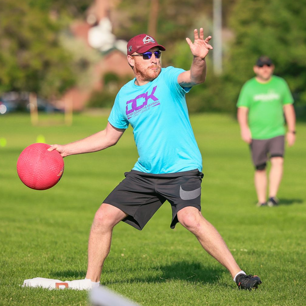 Female kickball player kicking the ball into play.