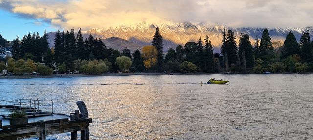 The lakefront at Queenstown with snow-capped mountains beyond