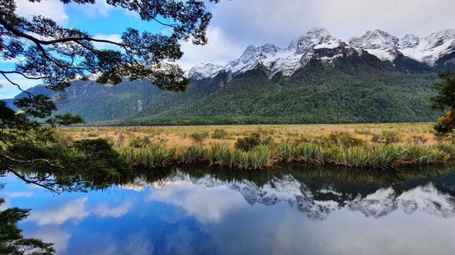 Snow-capped mountains reflected in still water