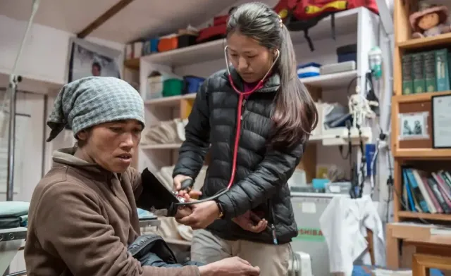 A nurse taking a patient’s blood pressure in a clinic