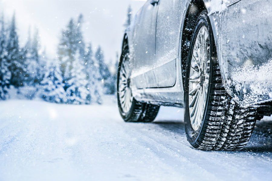 A car driving on a snowy road.