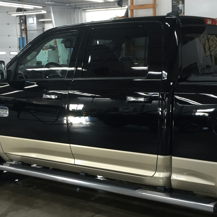 A pickup truck with the driver's side door fixed.