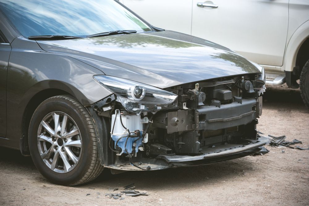 black car with front bumper damage