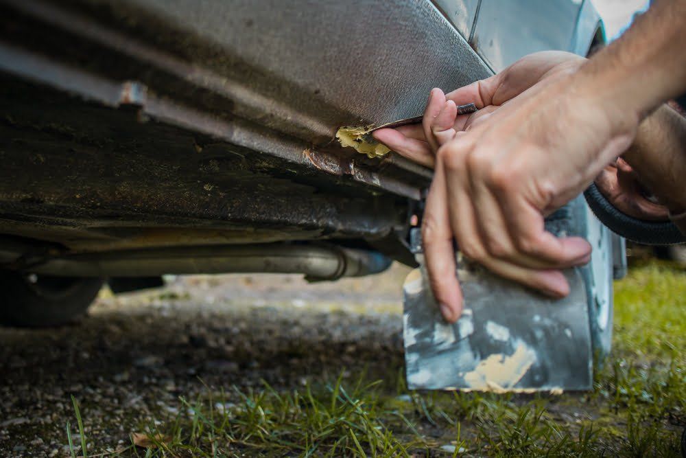 fixing the underside of a car with putty can help you know how to increase the value of your car